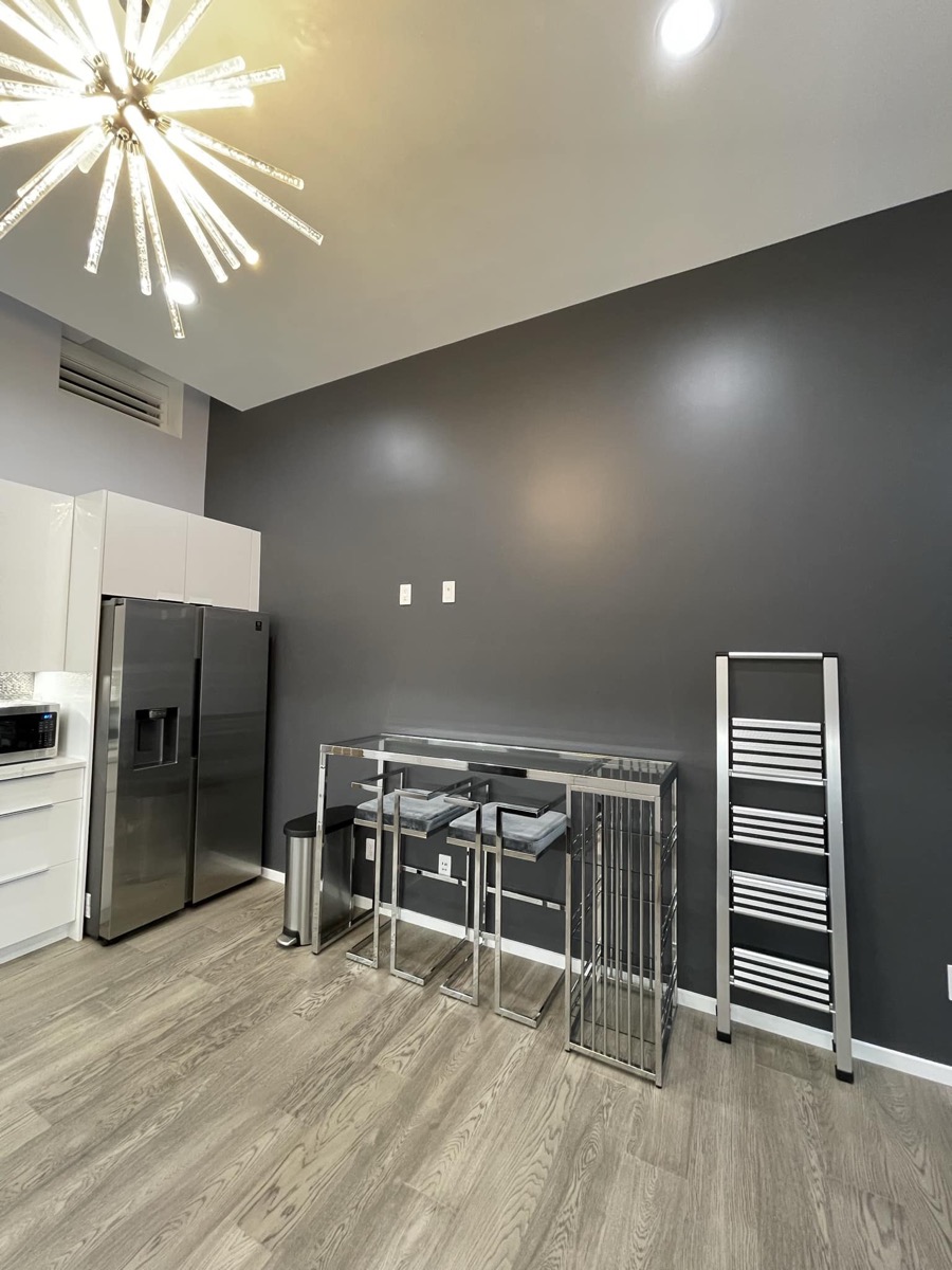 Modern kitchen with dining area and starburst chandelier