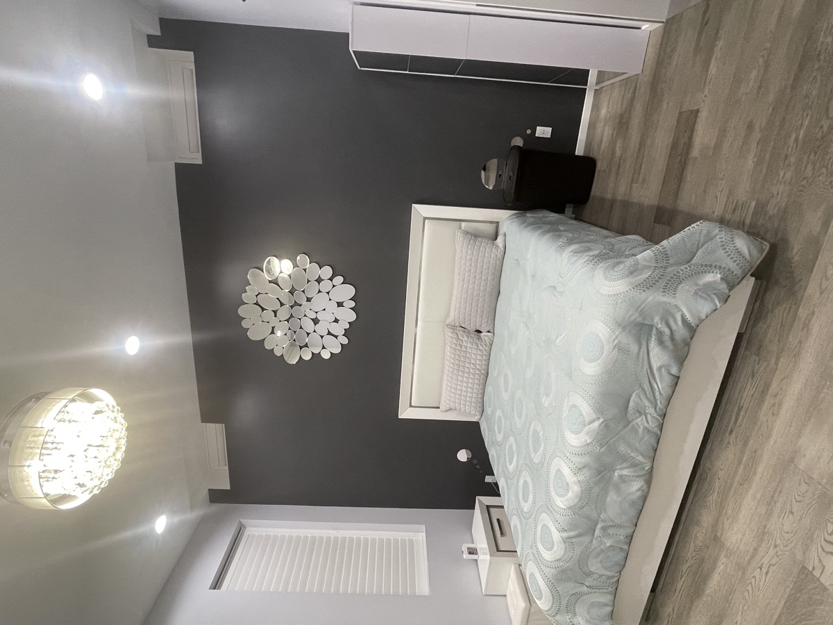 Bedroom view with bed and accent wall