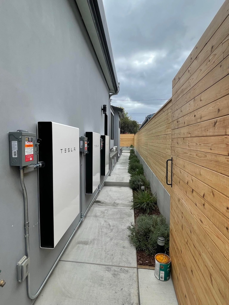 Side walkway with multiple Tesla Powerwalls